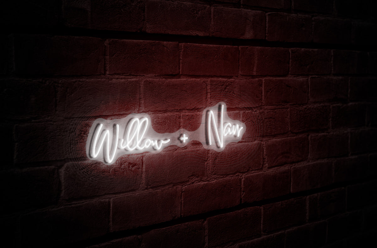 White neon cursive sign reading 'Willow + Naur' glowing on a dark red textured brick wall in shadow.
