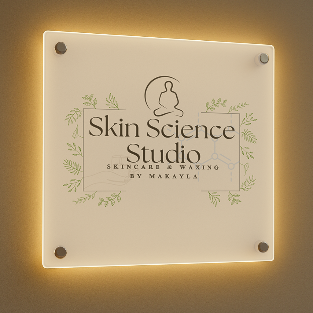Backlit frosted acrylic sign reading Skin Science Studio with botanical illustrations and Skincare & Waxing by Makayla.