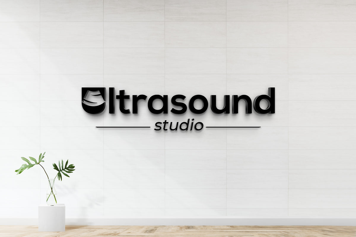 Black 3D 'Ultrasound' logo with U icon and 'studio' on white tiled wall, glass vase with green leaves on pedestal.