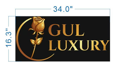 Black rectangular sign with gold rose crescent logo and 'GUL LUXURY' text; blue dimensions 34.0" by 16.3".