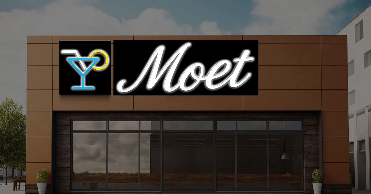 Custom Moet bar storefront LED neon sign with martini glass icon and white script wordmark on black panels, exterior cocktail lounge signage.