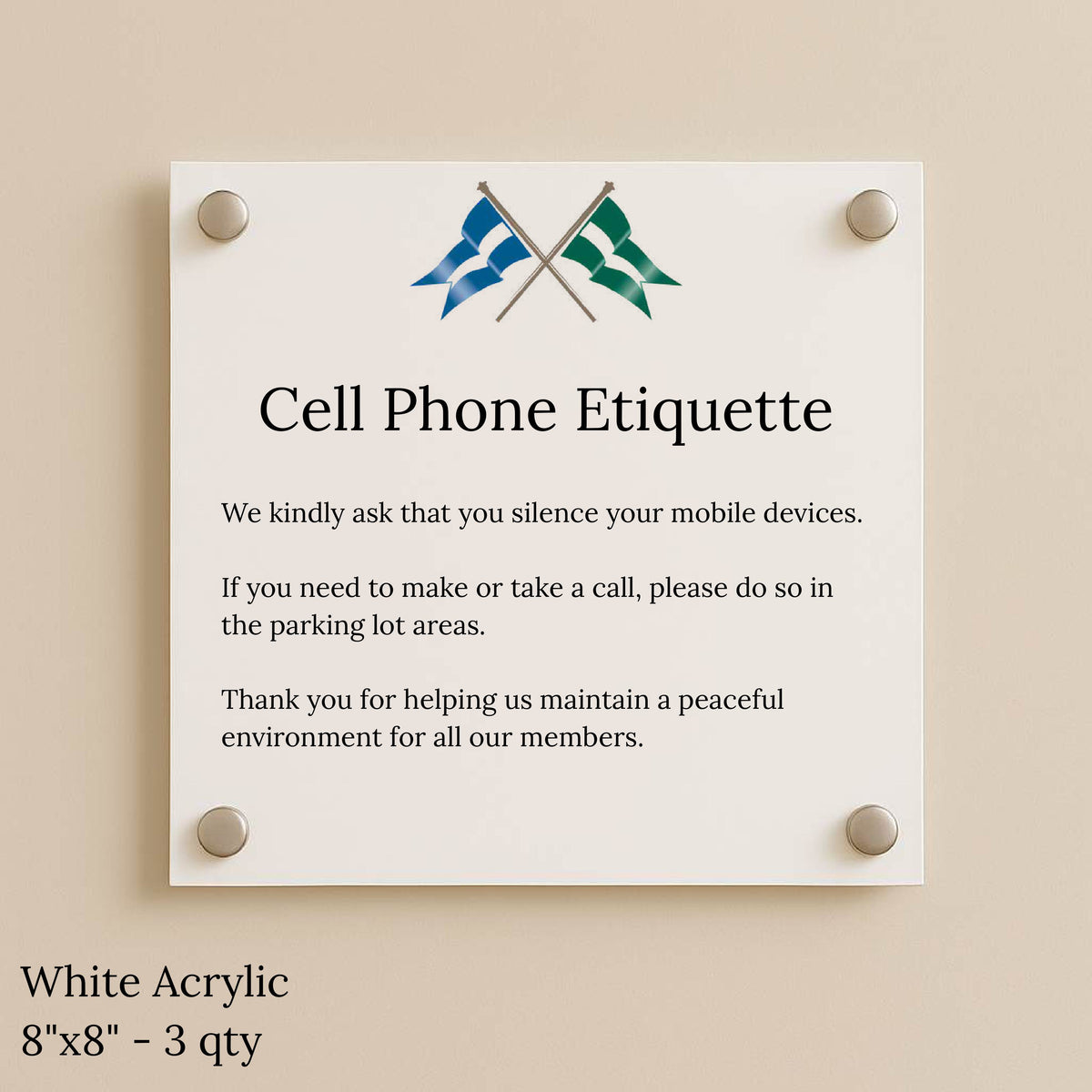 White acrylic sign with crossed blue and green flags and title 'Cell Phone Etiquette' asking guests to silence phones.