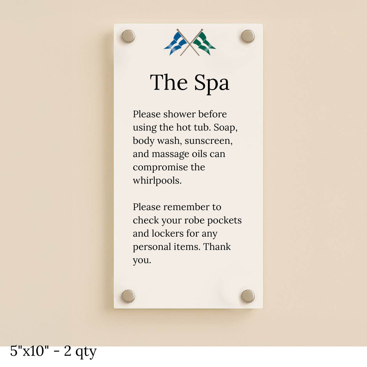 A cream glass spa sign mounted with four silver standoffs on a beige wall, titled 'The Spa' with shower rules.