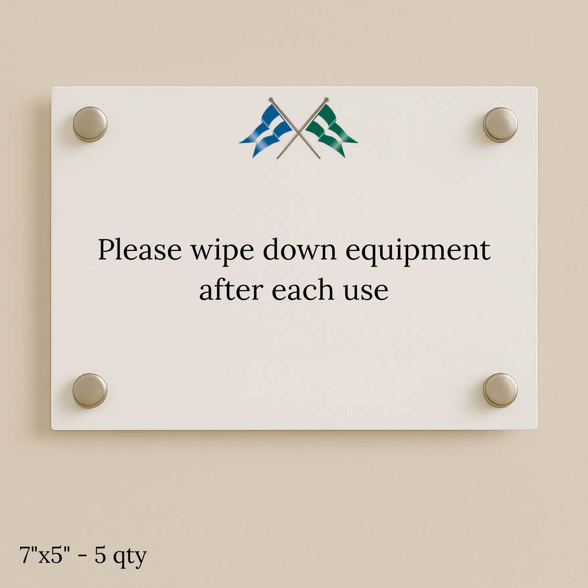 White glass sign on beige wall with four silver standoffs, crossed blue and green flags, and text to wipe equipment.