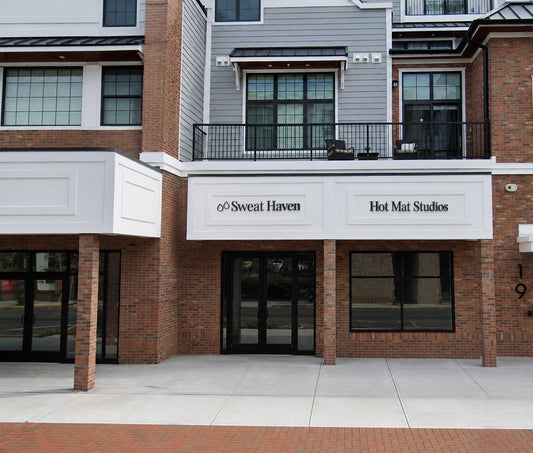 Custom black metal channel letter signs for Sweat Haven and Hot Mat Studios by Volt Signs design experts.