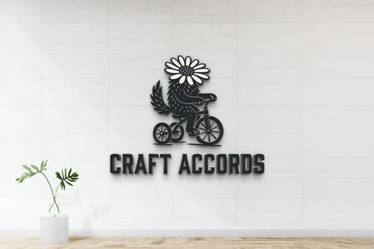 Black metal sign 'CRAFT ACCORDS' with daisy-headed creature on a tricycle mounted on white tiled wall, green vase plant.