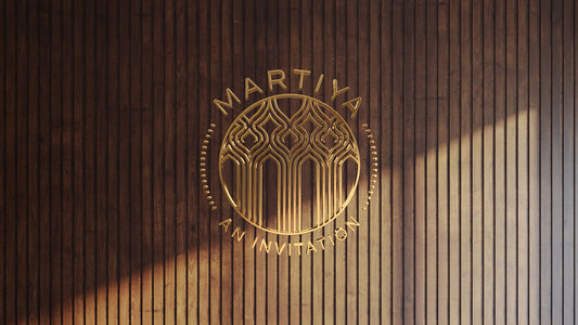 Gold metallic custom sign with intricate design and "Martiya An Invitation" text on vertical wood wall by Volt Signs