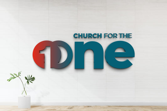 3D custom church signage reading Church for the One in blue and red mounted on white tiled wall with plant nearby