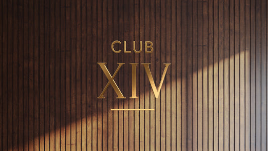 Non-lit 3D gold metal custom sign mockup reading Club XIV mounted on vertical dark wood slat wall by Volt Signs