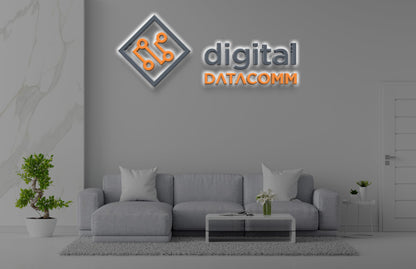 Digital Datacomm 3D halo backlit logo sign with orange circuit board diamond icon and gray wordmark on office lounge wall mockup.