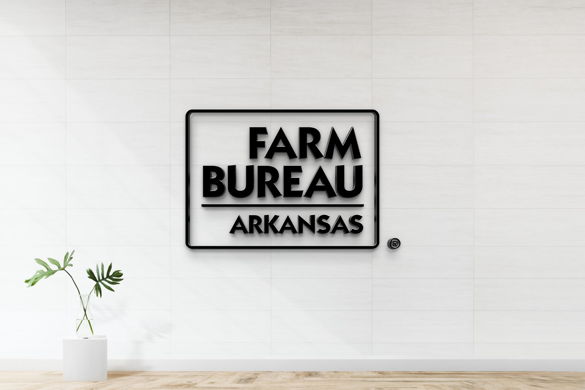 Farm Bureau Arkansas 3D logo sign mockup with rounded rectangle border, nonlit dimensional letters on office wall with elegant tile finish.
