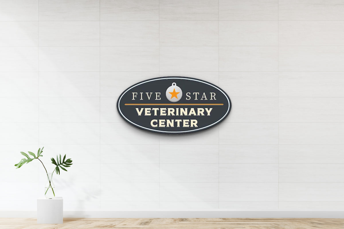 Oval navy sign 'FIVE STAR VETERINARY CENTER' with orange star medallion on white tiled wall, glass vase with leaves.