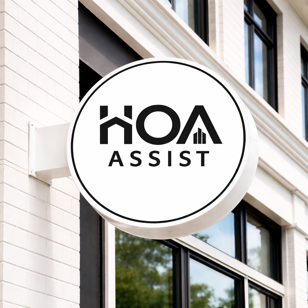 HOA Assist round double-sided blade lightbox sign with mounting bracket on white brick storefront facade, property management office signage.