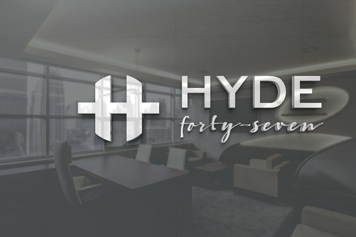 A metallic silver HYDE logo with stylized H and cursive 'forty-seven' overlays a blurred modern office interior.