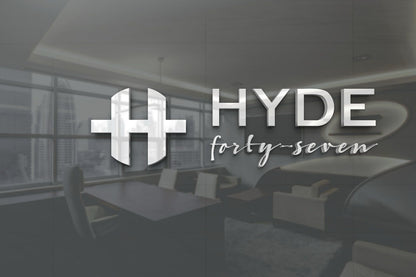 A metallic silver HYDE logo with stylized H and cursive 'forty-seven' overlays a blurred modern office interior.