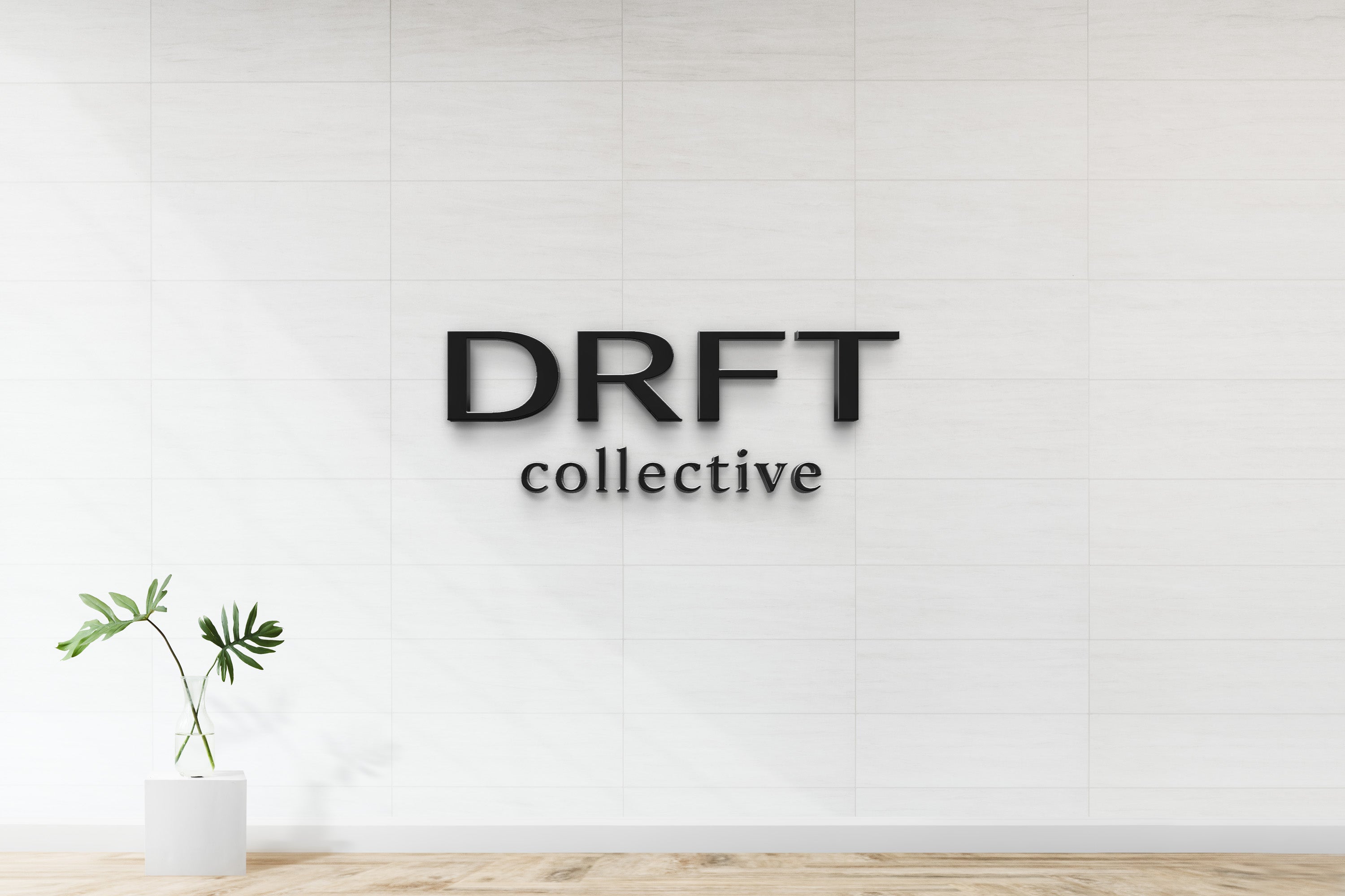 Custom DRFT Collective minimalist 3D dimensional black letter logo sign by Volt Signs on white tile interior wall, modern boutique brand signage.