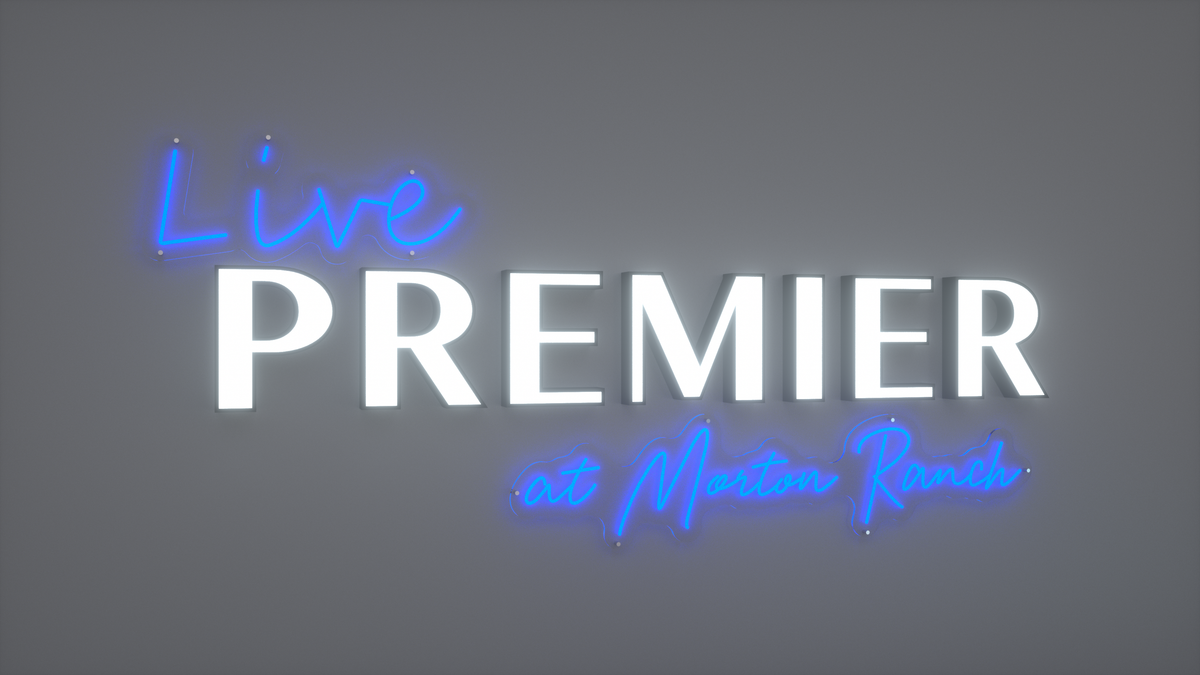 Blue neon script 'Live' and 'at Morton Ranch' with large white illuminated block letters spelling 'PREMIER' on gray.