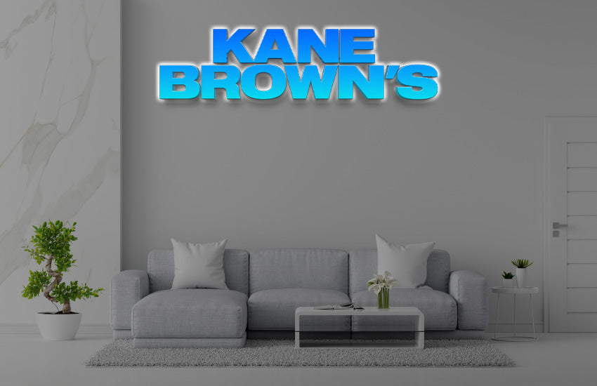 Custom Kane Brown's 3D halo backlit logo sign by Volt Signs with bold blue dimensional letters on office lounge wall mockup, country brand.