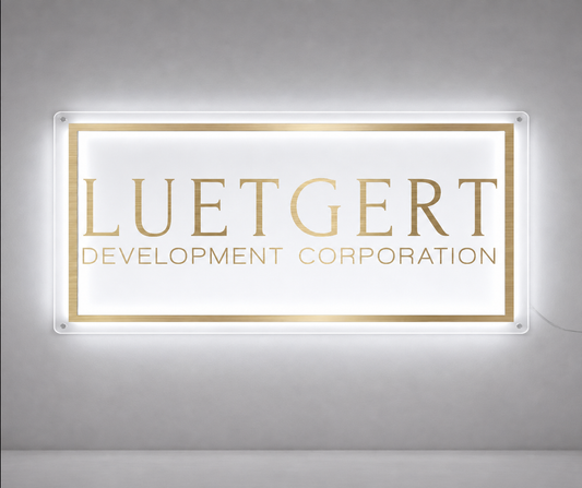 Backlit acrylic custom sign mockup with gold lettering and border for Luetgert Development Corporation by Volt Signs