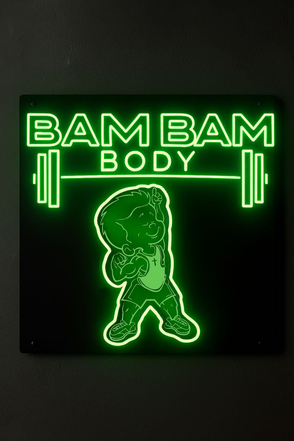 Glowing green neon sign on black wall reading BAM BAM BODY with barbell graphics and a flexing cartoon child mascot.