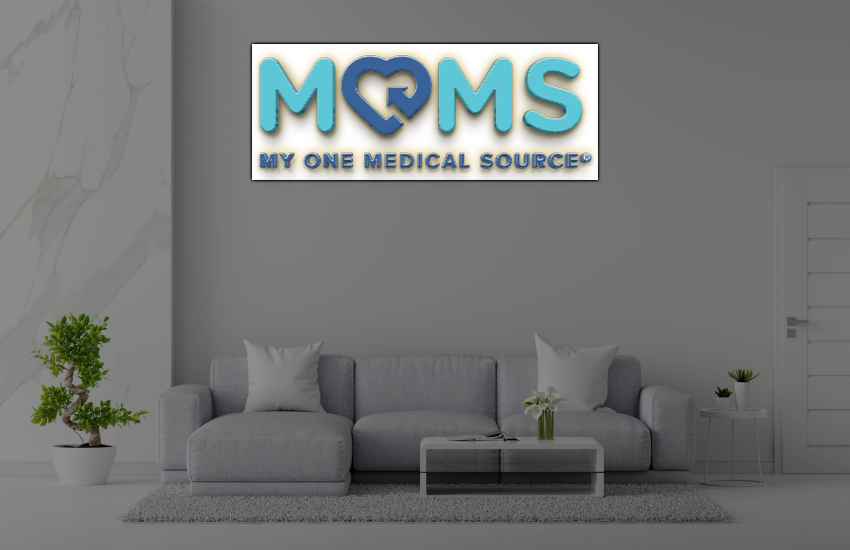 Modern gray living room with large blue-teal 'MOMS' sign reading 'My One Medical Source' above sofa.