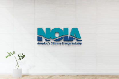 Teal and navy NOIA wave logo with text 'America's Offshore Energy Industry' on white tiled wall above monstera.