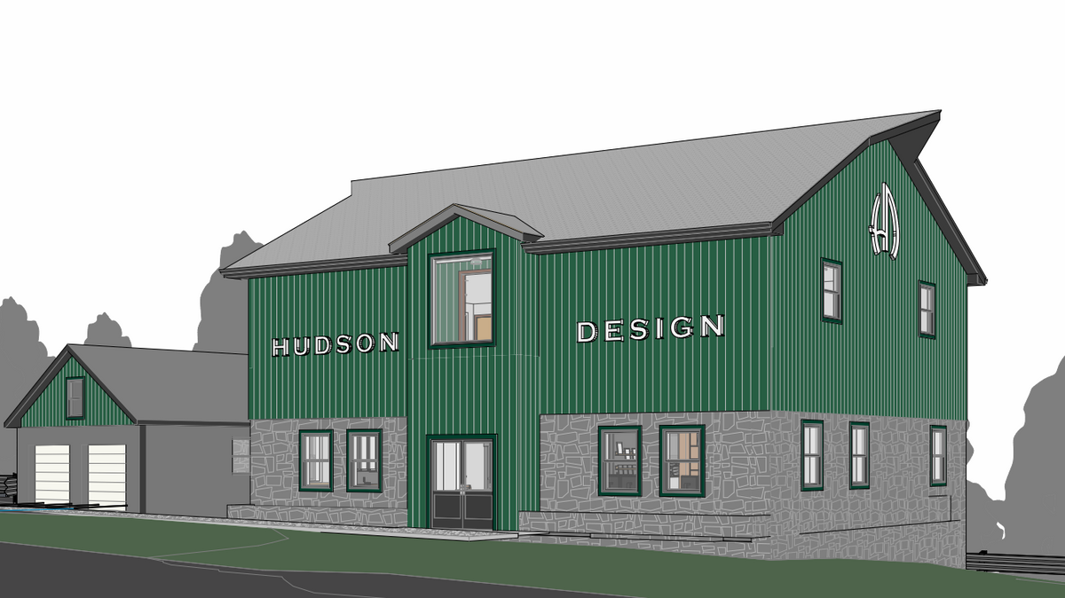 3D building mockup with custom exterior signage reading Hudson Design in white letters on green metal siding by Volt Signs.
