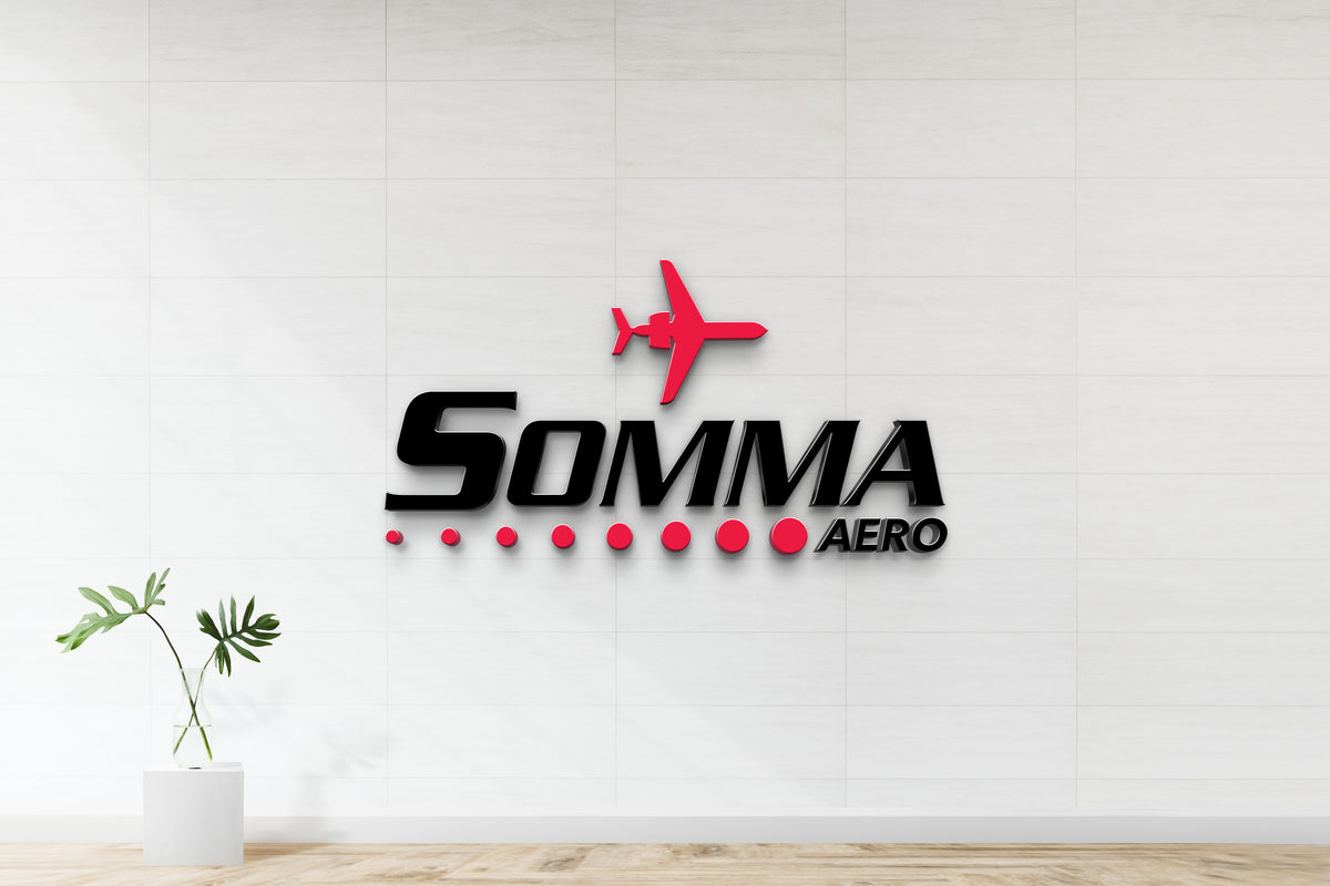 SOMMA AERO 3D logo on white tiled wall with red airplane icon, red dot row, black glossy letters, plant in glass vase.
