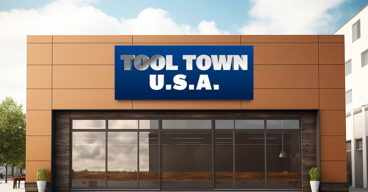 Custom Tool Town USA 3D metal dimensional letter sign by Volt Signs with chrome and white lettering on blue backplate, hardware retail storefront.