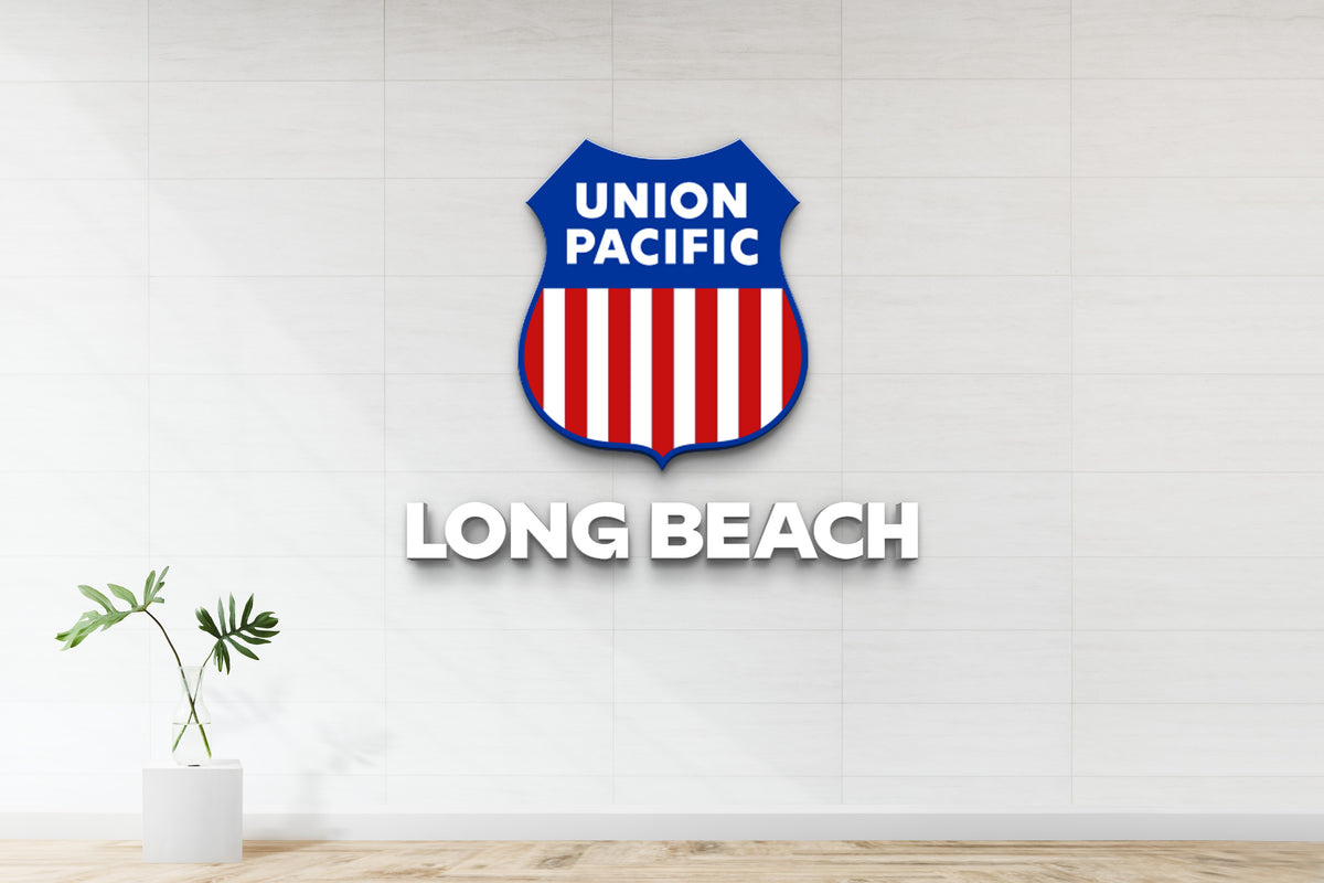 Union Pacific shield logo with blue top, red and white stripes above white 3D LONG BEACH text on tiled wall, glass vase.