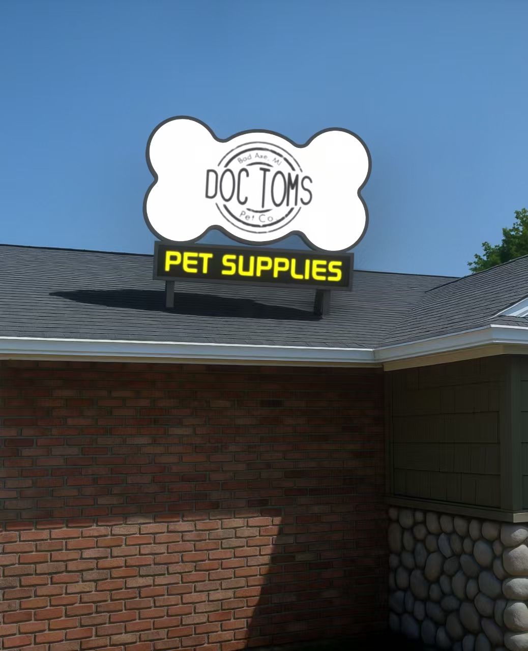 A rooftop dog-bone shaped white sign reading 'DOC TOMS' with a yellow 'PET SUPPLIES' panel on a brick building.
