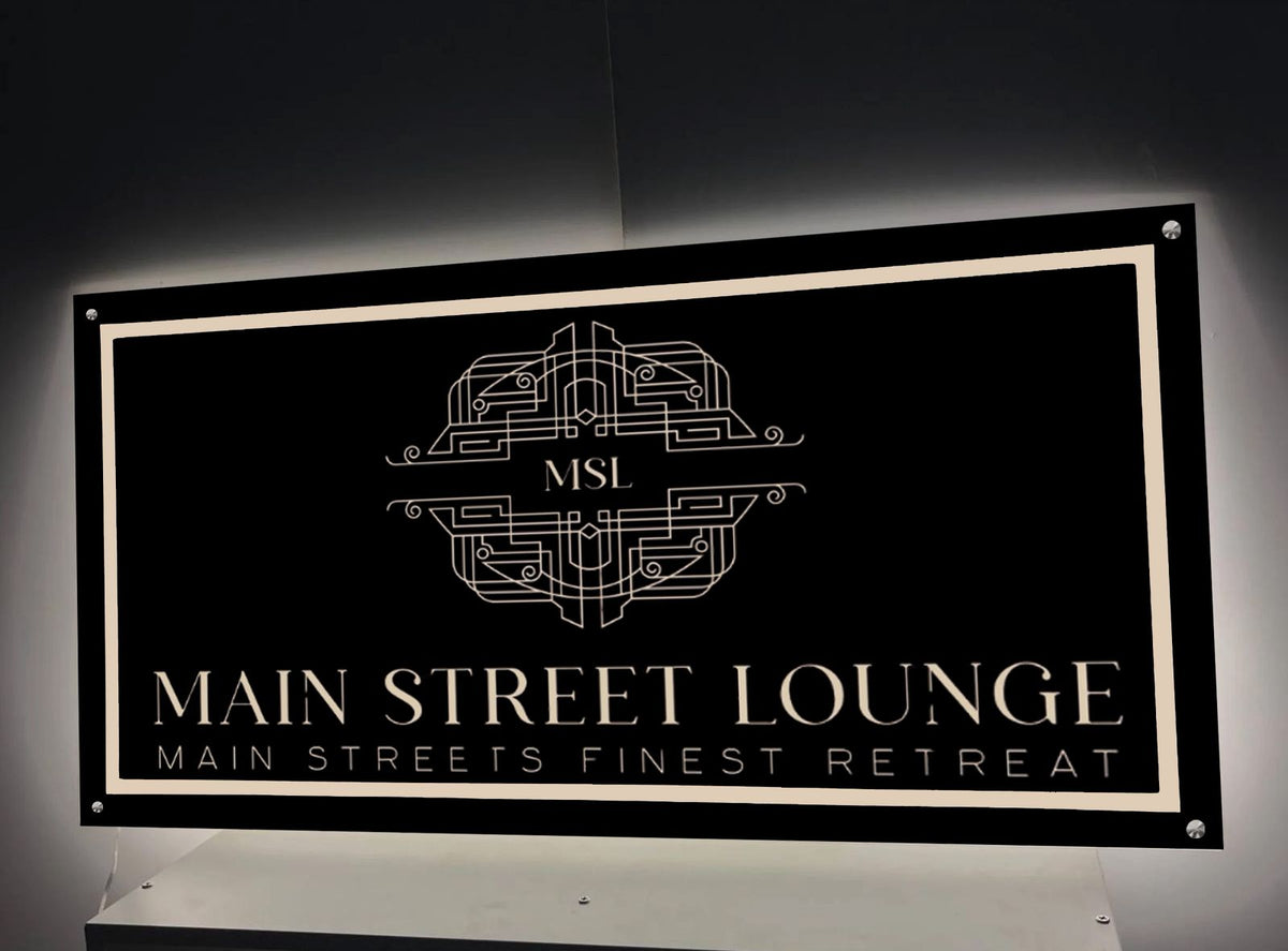 Black rectangular sign with cream border, art-deco emblem 'MSL', gold 'MAIN STREET LOUNGE' text and small tagline.