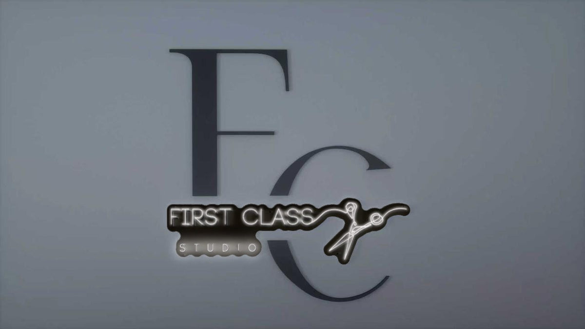 Gray wall with large dark 'FC' letters behind a glowing neon black-and-white 'FIRST CLASS STUDIO' sign and scissors.
