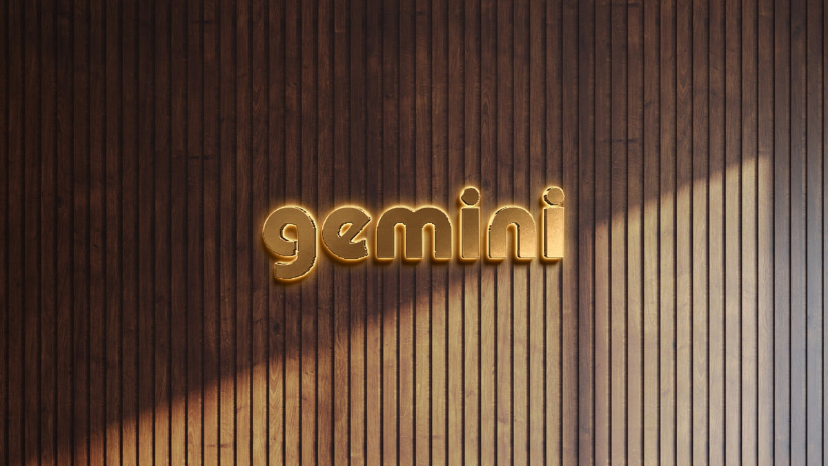 Golden illuminated 3D 'gemini' sign centered on dark vertical wood slat wall, warm diagonal sunlight and shadow.