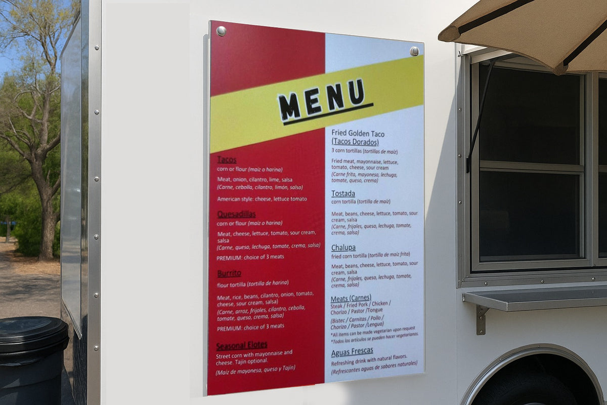 A colorful menu sign displays 'MENU' on a yellow diagonal, with red and white columns on a white food truck.