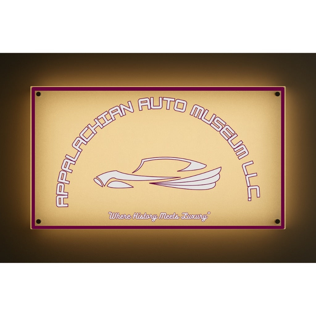 Backlit beige sign reading Appalachian Auto Museum LLC over a stylized car with tagline 'Where History Meets Luxury'.
