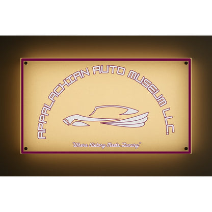 Backlit beige sign reading Appalachian Auto Museum LLC over a stylized car with tagline 'Where History Meets Luxury'.