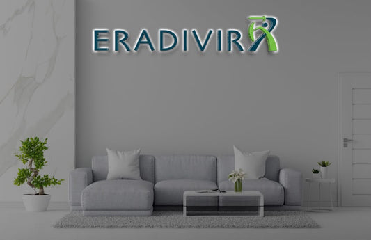 Modern living room with a gray sofa and Volt Signs ERADIVIR custom sign and signage displayed above the couch