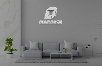 Gray living room with three-seat sofa, glass coffee table, potted bonsai, marble panel and illuminated DIAZ RACK logo.