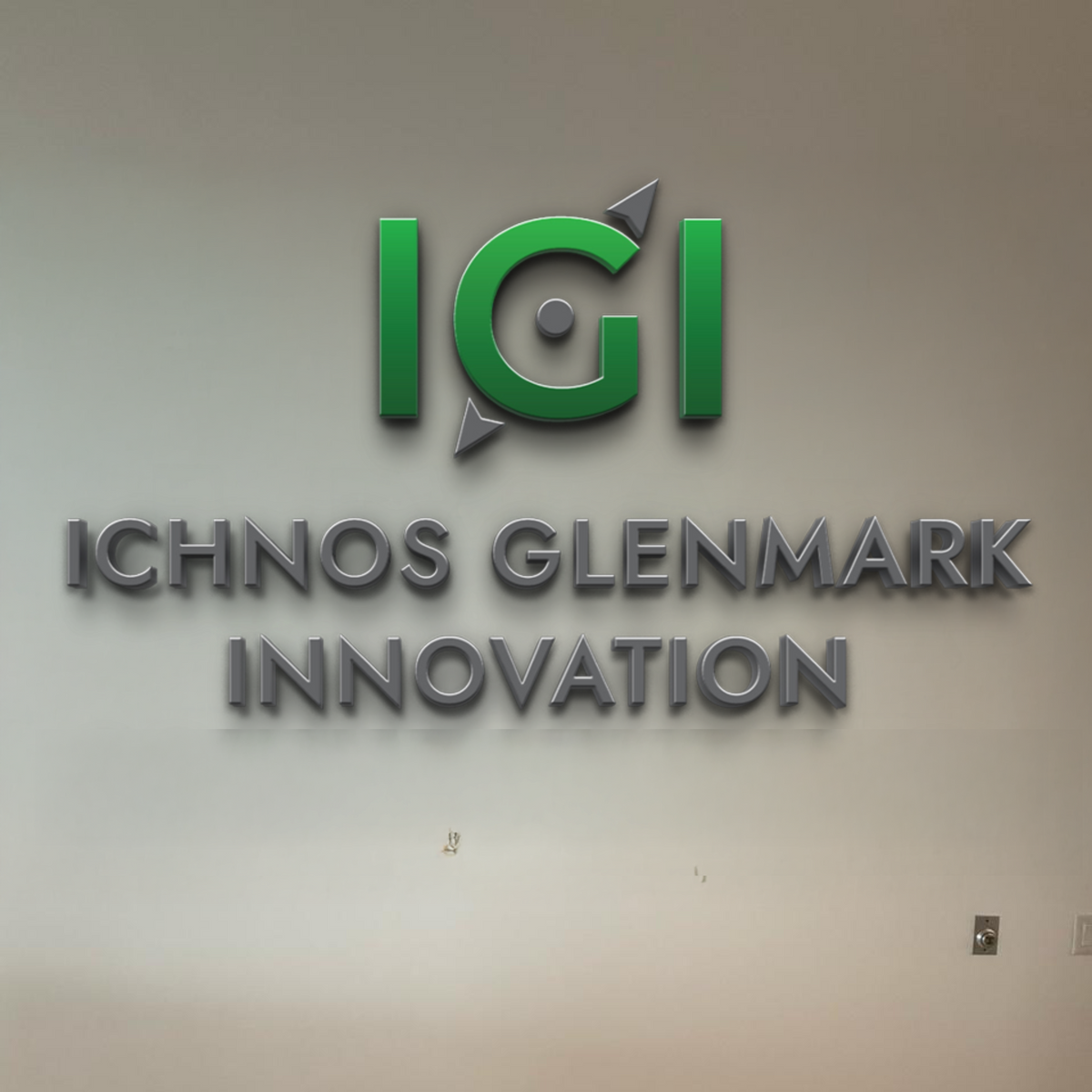 Volt Signs custom sign with a green circular logo and arrows above raised metallic ICHNOS GLENMARK INNOVATION signage