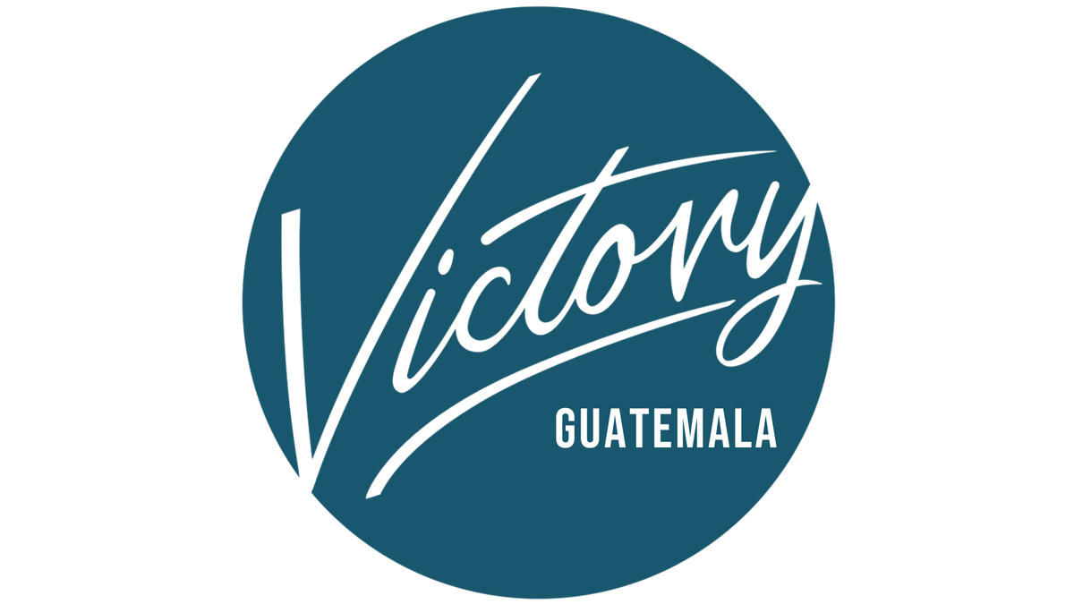 Round blue custom sign with cursive "Victory" and bold "Guatemala" text for Volt Signs branding and signage.