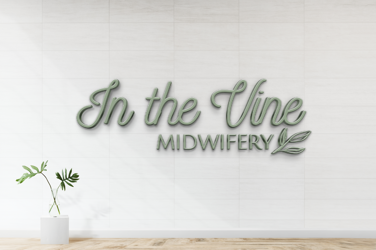 Green 3D cursive 'In the Vine' and block 'MIDWIFERY' logo with leaf icon on white tiled wall, glass vase.