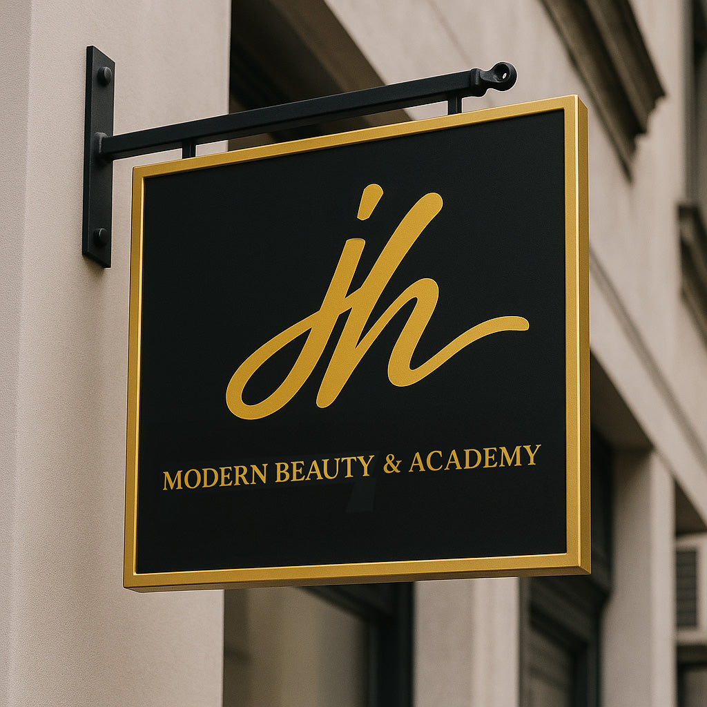 A black and gold hanging storefront sign displaying a stylized gold 'jh' logo and text Modern Beauty & Academy.