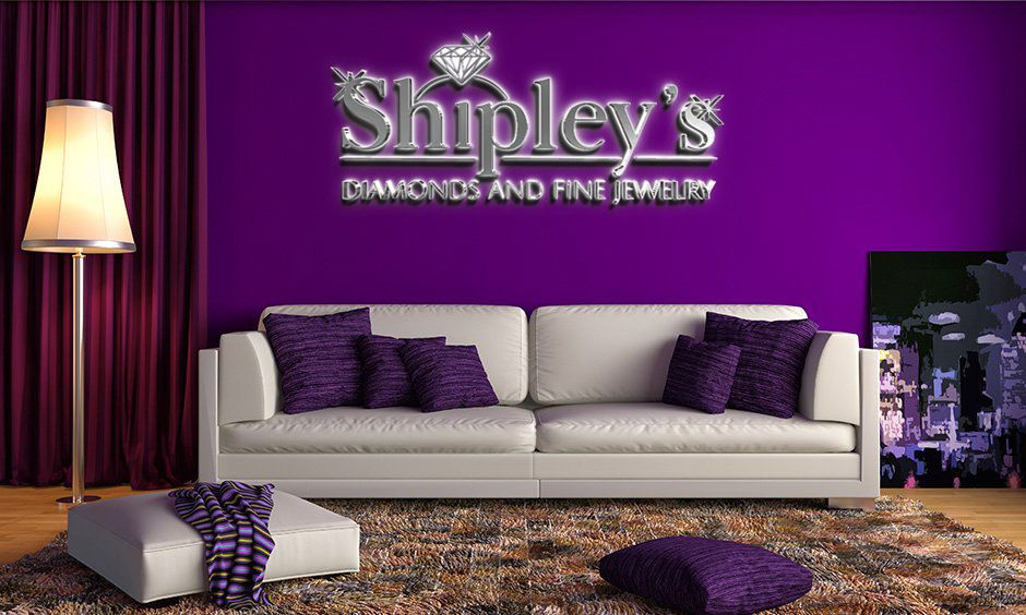 Purple living room with silver 'Shipley's Diamonds and Fine Jewelry' sign, white sofa, purple pillows, floor lamp.
