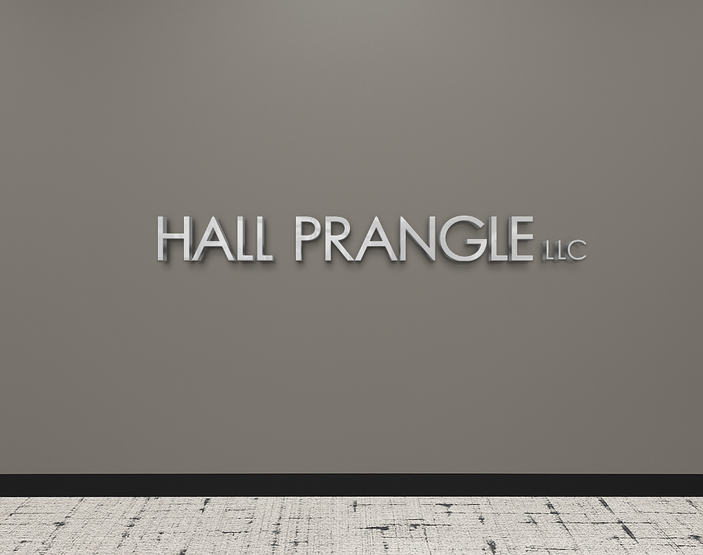 Silver 3D letters spelling 'HALL PRANGLE LLC' mounted on a gray office wall above a patterned carpet.