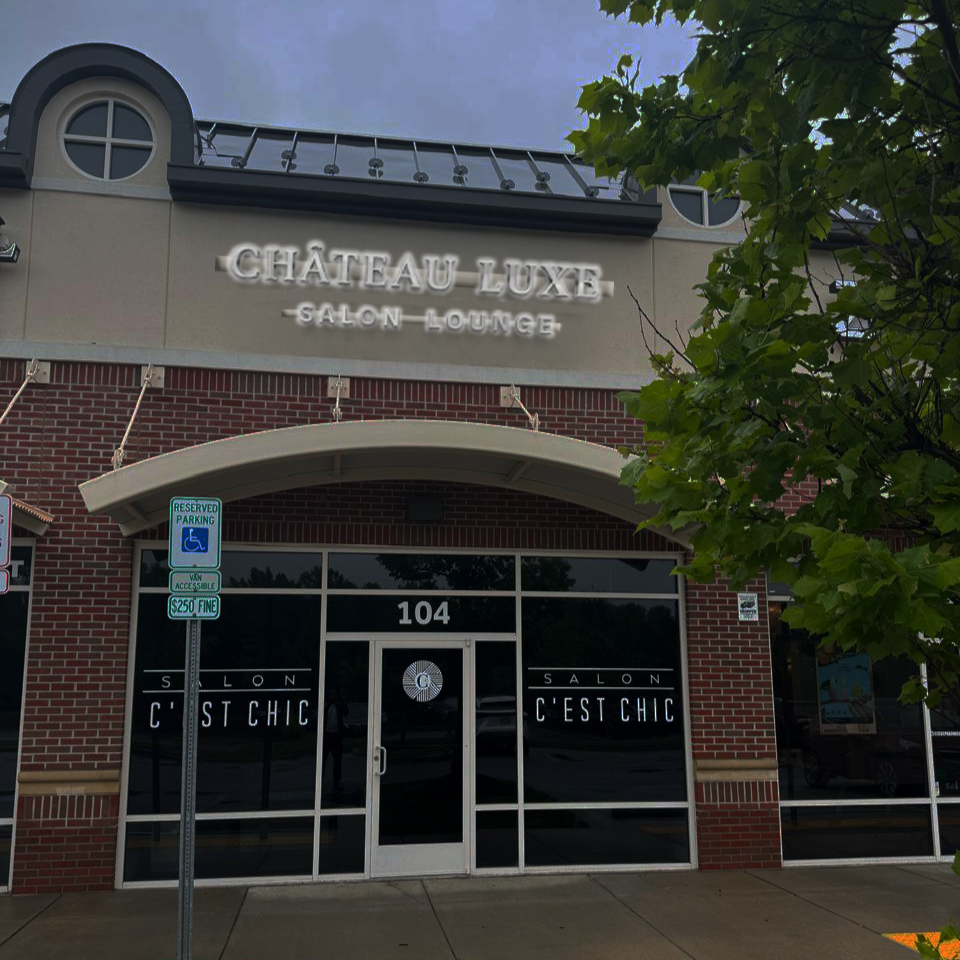 A brick storefront 104 displays Château Luxe Salon Lounge and C'EST CHIC windows with Volt Signs custom sign and signage